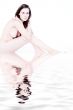 Naked woman sitting and watching