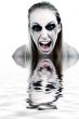 Studio portrait of a young blond woman in horror