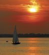 Yacht sailing in sunset