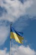 Ukrainian state flag upon blue sky