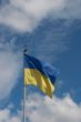 Ukrainian state flag upon blue sky