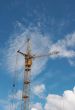 Lifting construction crane at blue sky