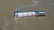 Message in a bottle with SOS signal