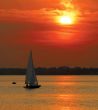 Yacht sailing into sunset