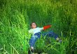 Happy young boy rests upon herb and dreaming