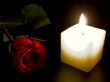 Candle and red rose