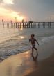 happy young boy running on the beach at sunset 2