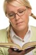 Female With Ponytails Reads Her Book