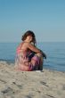 Young woman sitting on the seashore