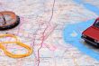 Fragment of a map with a compass and model of the automobile