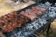 Preparing meat barbecue upon open fire