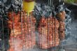 Preparing meat barbecue upon open fire