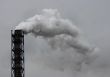 Smoking industrial pipe on gray sky