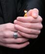 Flaming candle upon palms protection