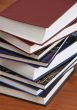  	Stack of new books with hard cover spine