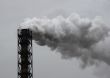 Smoking industrial pipe on gray sky