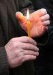 Flaming candle upon palms protection