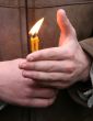 Flaming candle upon palms protection