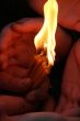 Flaming candle upon palms protection