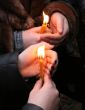 Flaming candle upon palms protection