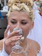 Young bride drinking champagne