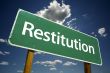Restitution Road Sign