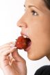 Bitting into a strawberry