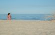 Young woman is sitting on the beach 2