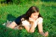 girl lays on a grass