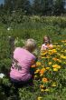 elderly woman is taking photos of girl (focus on girl)