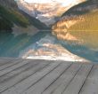 calm lake at the bottom of mountains with dock