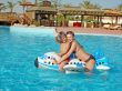 Caucasian family at pool having fun in a pool