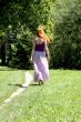 Young woman strolling on a summer meadow.