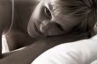 Blond in lingerie thinking while in bed