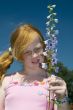Girl with larkspur flower