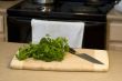 Food on a cutting board with chef`s knife