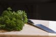 Food on a cutting board with chef`s knife