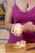 Woman peeling an onion