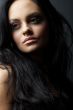 brunette girl posing on dark background