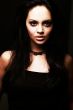 brunette girl posing on dark background
