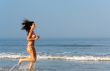 Beautiful girl running on the beach