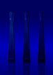 Three blue isolated bottles on blue background
