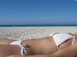 girl in a white bikini tanning