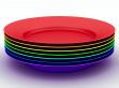 Set of plates in colours a rainbow. 3D image.
