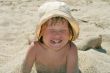Baby girl plays with a sand