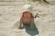 Baby girl plays with a sand