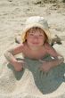 Baby girl plays with a sand