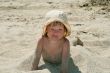 Baby girl plays with a sand