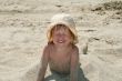 Baby girl plays with a sand
