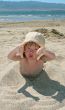 Baby girl plays with a sand